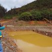 Seorang pegawai PT Gag Nikel memperlihatkan kolam penampungan air bekas tambang yang berada di Pulau Gag, Distrik Waigeo Barat Kepulauan, Kabupaten Raja Ampat, Papua Barat Daya, pada 8 Juni 2025. (Antara/Mulalinda).